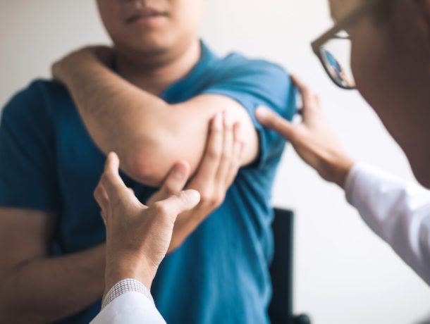 Doctor examining elbow pain